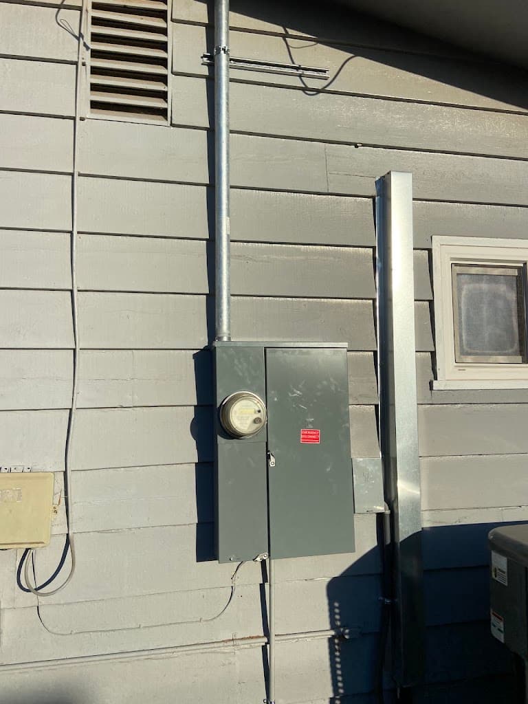 Exterior electrical meter panel with new conduit riser installed on a house